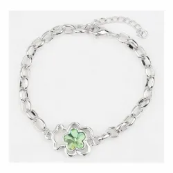 Brazalete dorado con un oso verde esmaltado como pieza central.