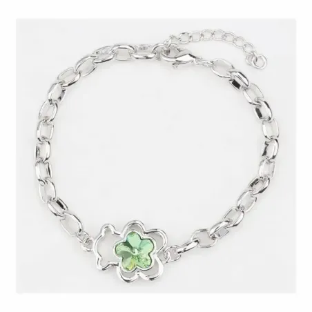Brazalete dorado con un oso verde esmaltado como pieza central.