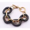 Brazalete de bisutería de eslabones gruesos en tonos dorado y negro