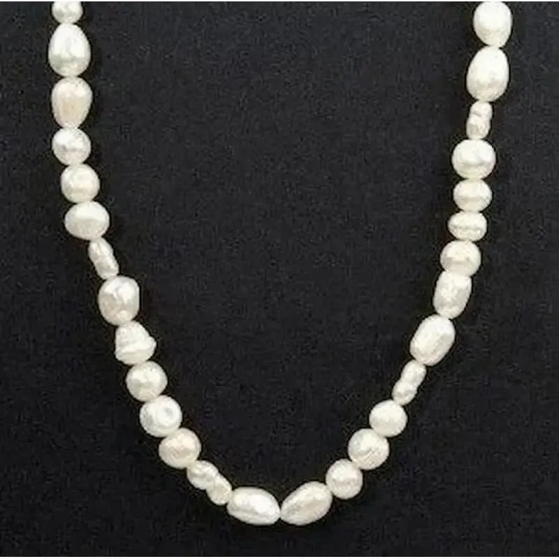 Collar de bisutería con perlas blancas cultivadas y cierre de plata 925, mostrando su brillo y caída natural.