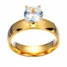 Anillo bisutería chapado en oro con piedra central brillante, sobre fondo claro mostrando su diseño elegante.