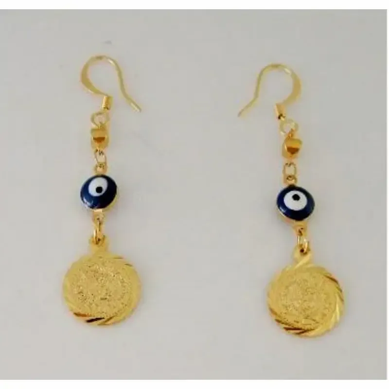 Pendientes bisutería mujer con monedas doradas y ojos turcos chapado oro, sobre fondo azul noche.