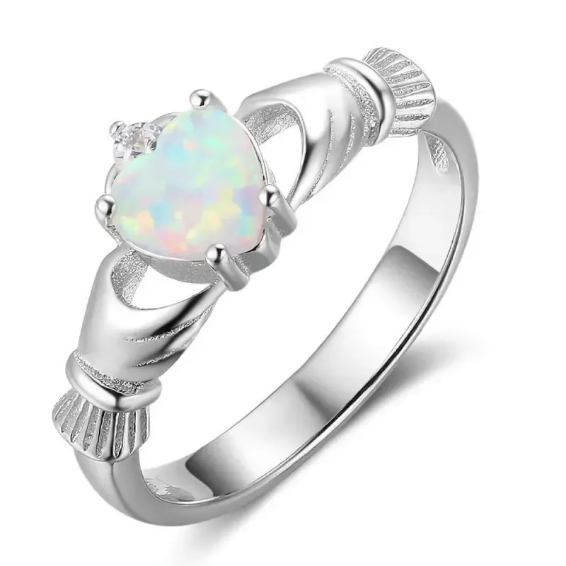 Anillo de plata esterlina con diseño Claddagh y piedra de ópalo en el centro, acabado brillante.