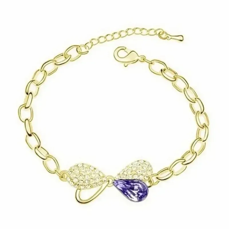 Pulsera dorada con lazo decorado con cristales púrpura y blanco sobre cadena fina