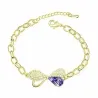 Pulsera dorada con lazo decorado con cristales púrpura y blanco sobre cadena fina