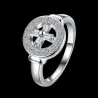 Anillo plateado brillante con piedras blancas pequeñas en la montura.